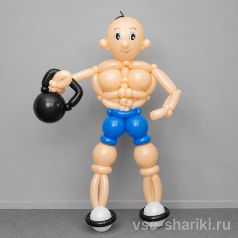 Фигура бодибилдера с чёрной гирей и в синих шортах